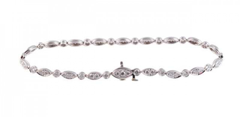 Tiffany: A diamond bracelet, the eighteen articulated leaf shaped links each set with two brilliant cut claw set diamond highlights, alternately set with seventeen collet set brilliant cut diamonds. Integral tongue fastening with safety clip. Makers mark 