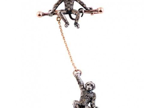 A late Victorian paste set brooch, realistically designed as two monkeys,...