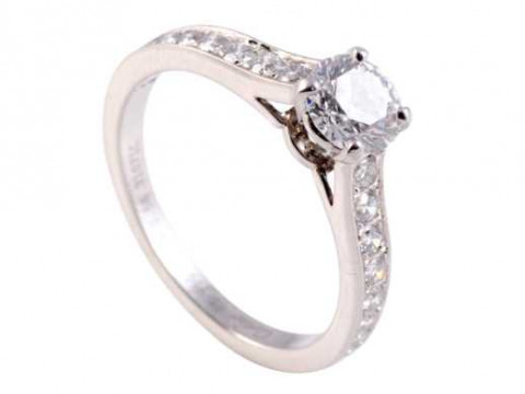 Cartier: A diamond ring, the central brilliant cut diamond four claw set...