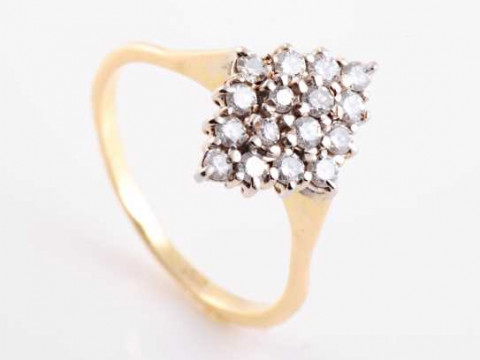 A diamond ring, the marquise shaped mount set to the centre with four...