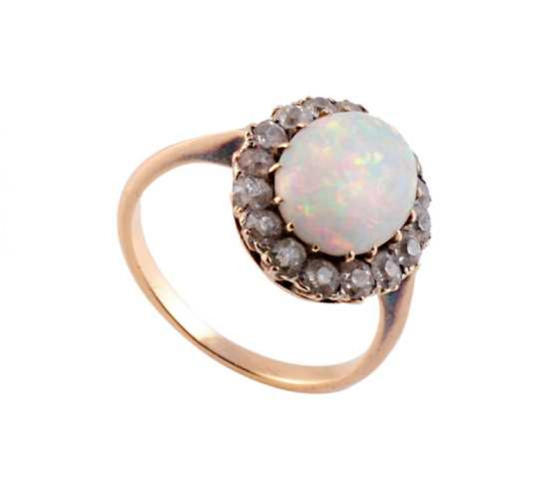 An opal and diamond ring, the oval cut opal claw set within a bezel of