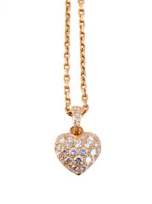 Cartier: A diamond set pendant, the heart shaped pendant set with twenty eight brilliant cut graduating diamonds, all set in an open mount, suspending from an oval shaped mount set with four graduating brilliant cut diamonds, in turn suspending from an ov