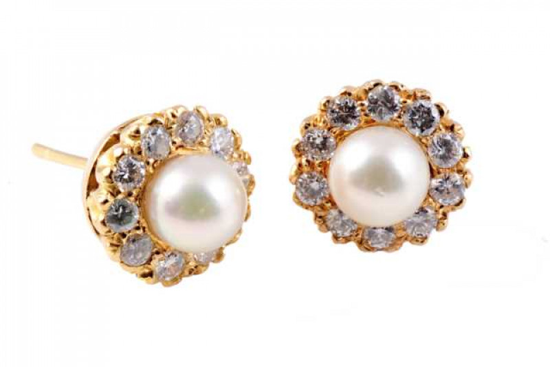 A pair of diamond and cultured pearl ear studs, the cultured pearl set within a bezel of ten brilliant cut claw set diamonds, all set in a pierced detail mount with post and scroll fittings. (Lacking scrolls). Weight of one earring approx. 1.7gms.