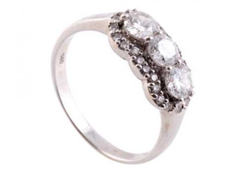 A diamond ring, the three uniform brilliant cut claw set diamonds raised...