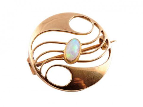 Murrle Bennett: An opal and gold roundel brooch, circa 1900, the symmetrically...