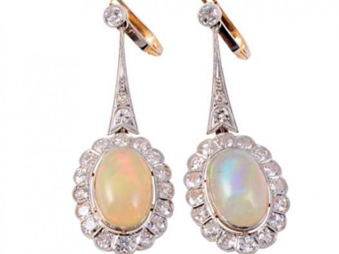 A pair of opal and diamond drop earrings, the oval cut opal collet set...