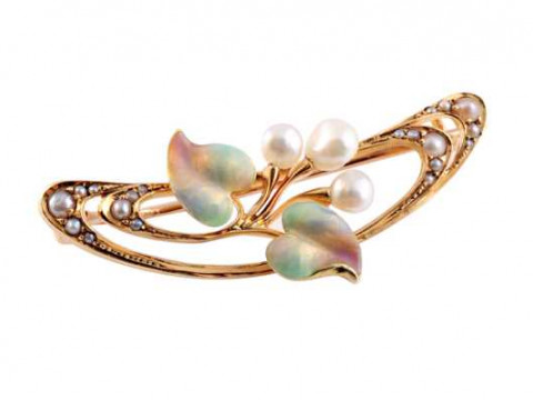 An Art Nouveau cultured pearl and enamel brooch, the open curved design...