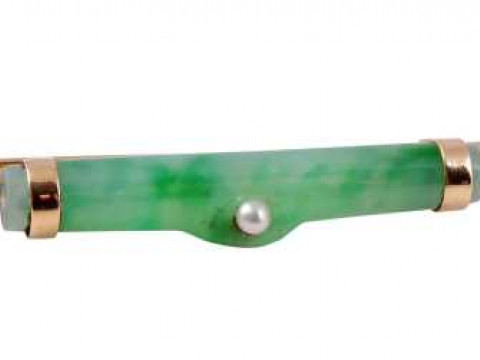 A jadeite and seed pearl bar brooch, the cylindrical jadeite set to the...