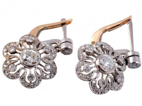 A pair of diamond drop earrings, circa 1900, set to the centre with an...