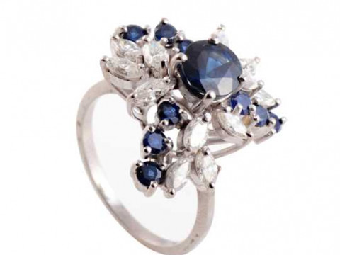A sapphire and diamond ring, the circular mixed cut four claw set sapphire...