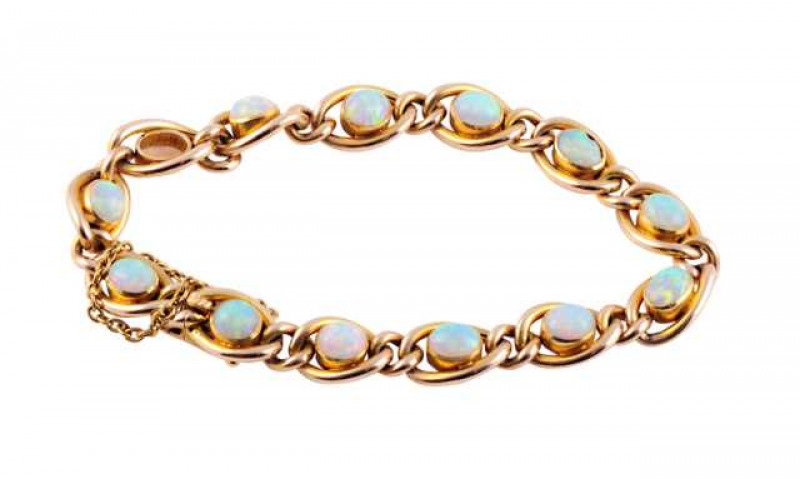 A Victorian opal and gold bracelet, the thirteen heavy oval links each set to the centre with a collet set oval cut opal, each articulated link alternately spaced with a smaller articulated heavy oval link, all on an integral tongue fastening with safety 