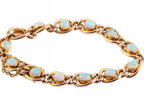 A Victorian opal and gold bracelet, the thirteen heavy oval links each...