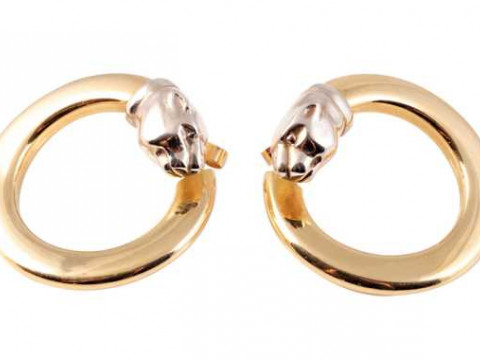 A pair of yellow coloured metal ear studs, the stylised forward facing...