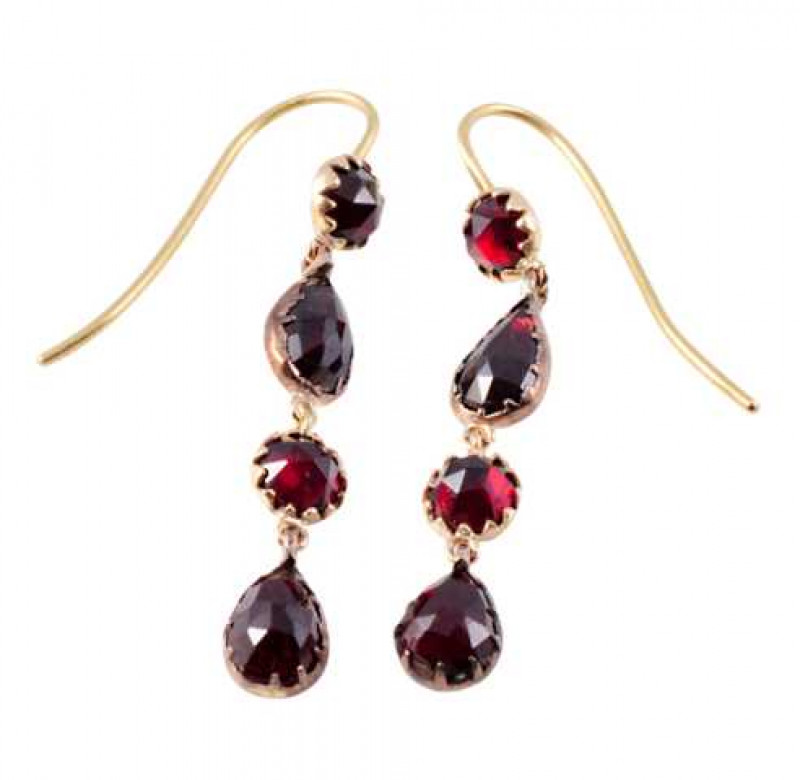 A pair of garnet drop earrings, the round mixed cut garnet collet set in a shaped mount, suspending three articulated drops, the middle drop set with a round mixed cut garnet in a similar collet shaped mount, between two further drops each set with a claw