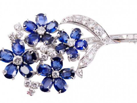 Cartier: A sapphire and diamond brooch, modelled as a spray of flowers,...