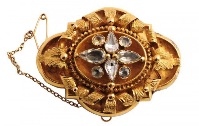 A Victorian white stone locket mourning brooch, set to the top with four marquise cut and four round cut collet set stones, all within a slightly concave beaded and rope work detail mount, in turn within an elaborately moulded and shaped mount with beaded
