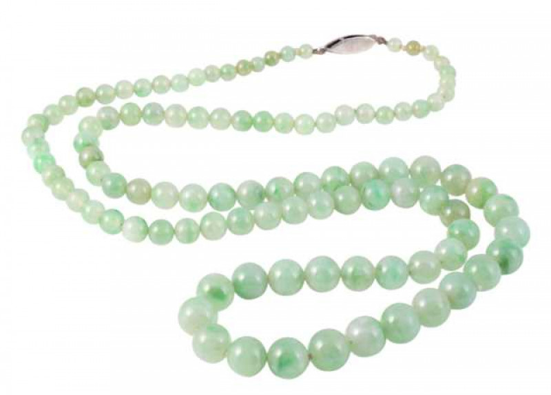 A jadeite beaded necklace, the one hundred and two graduating jadeite beads strung simply onto an oval integral clasp with delicate engraved detailing and set to the centre with a single marcasite highlight. Length approx. 33cm. Weight approx. 55gms.