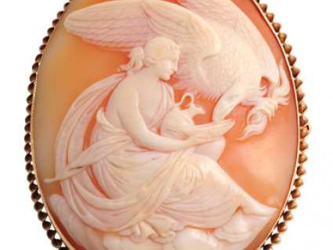 A cameo brooch, circa 1890, the oval cameo depicting an eagle eating from...