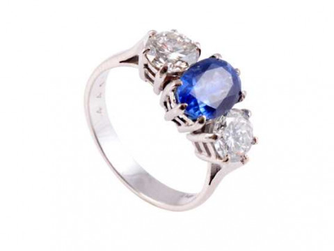 A sapphire and diamond ring, the central oval cut sapphire six claw set...