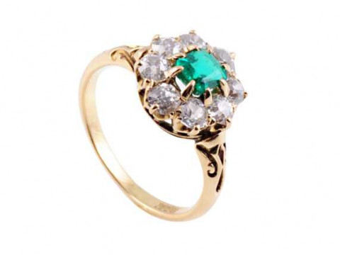 An emerald and diamond ring, the square cut emerald eight claw set within...