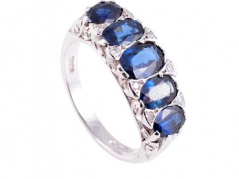 A sapphire and diamond ring, the five oval cut graduating sapphires and...