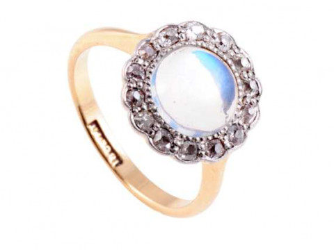 A moonstone and diamond ring, the round cabochon cut moonstone set within...