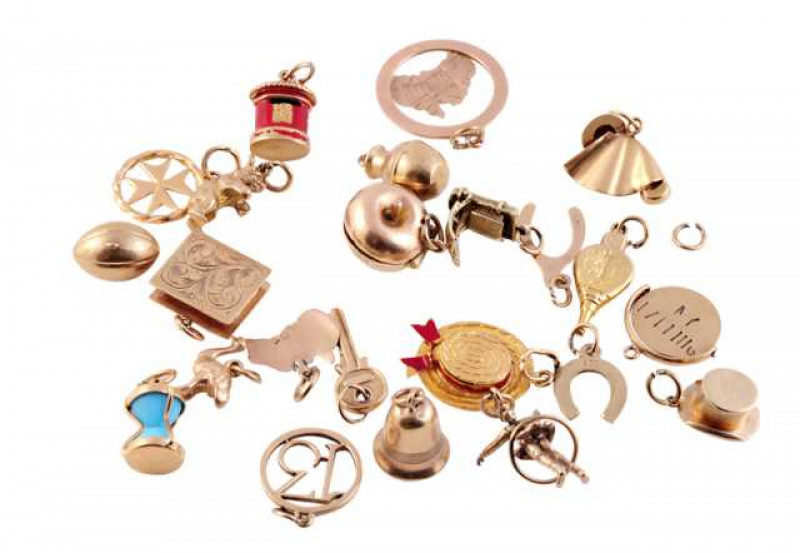 A collection of twenty three charms, to include a bell, two hats, a book, a horseshoe etc, most stamped 375 or 750. Total weight approx. 37.3gms.