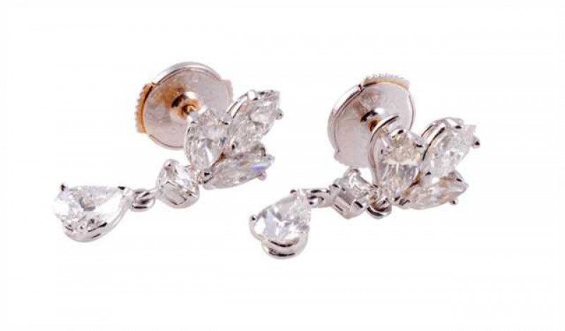 Cartier: A pair of diamond drop earrings, the pear cut diamond three claw set in an open mount, suspending from an articulated link from a princess cut claw set diamond, in turn suspending on an articulated link from a mount of three marquise cut claw set