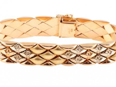 A yellow gold bracelet, of articulated moulded shaped links, four sections...