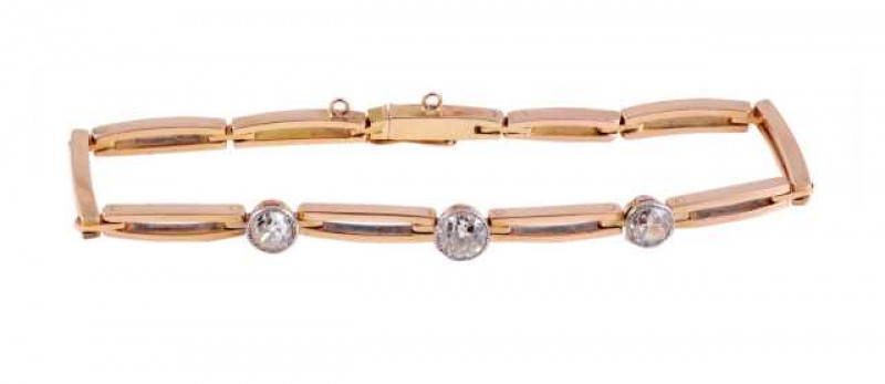 A diamond bracelet, the eleven oval shaped double bar links set to the centre with three evenly spaced graduating brilliant cut diamonds in collet settings, with integral tongue fastening and figure 8 safety catch. Length approx. 19cm. Weight approx. 12.9