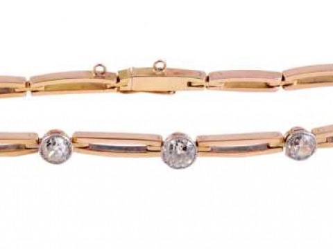 A diamond bracelet, the eleven oval shaped double bar links set to the...
