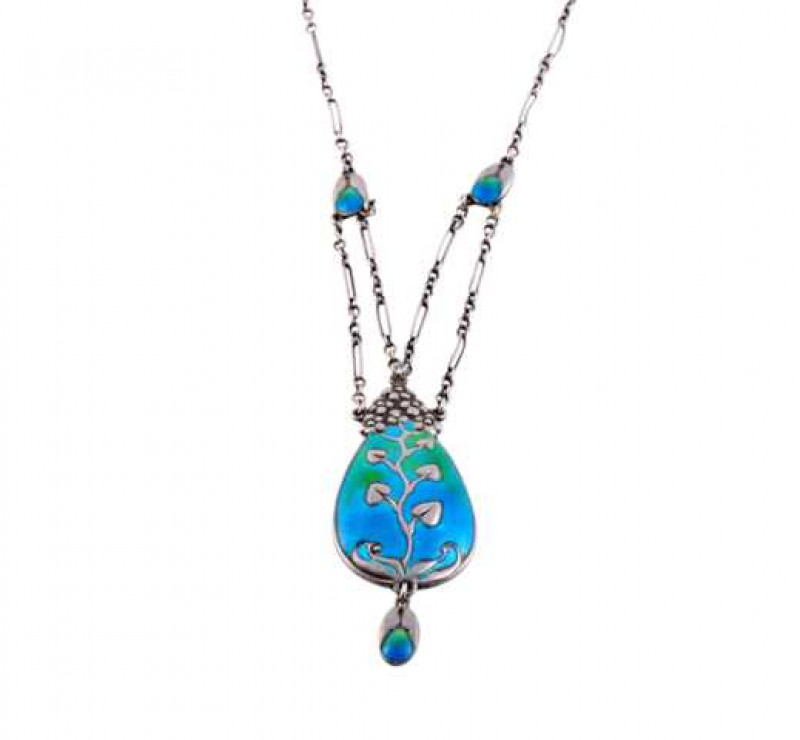 Murrle Bennett: An Art Nouveau silver and enamel necklace, the oval pendant drop set with blue and green enamel with an applied leaf and flowerhead detail, suspending an articulated oval drop with similar blue and green enamel detailing to the lower secti