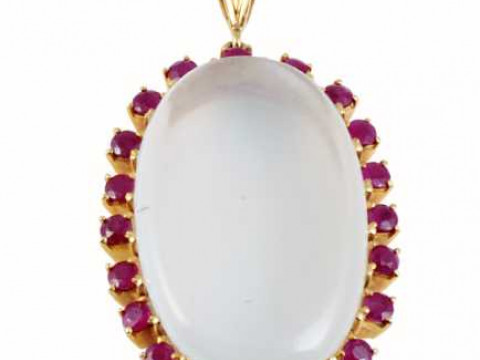 A moonstone and ruby pendant, the large oval cut moonstone claw set within...