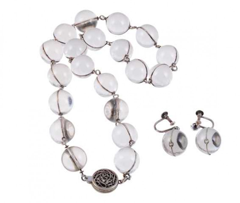 A rock crystal necklace, the twenty uniform rock crystal beads as articulated links held by a circular pierced detail integral tongue clasp. Length approx. 25.5cm Weight approx. 74.7gms; and a pair of earrings to match, the rock crystal bead suspending an