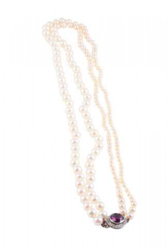 A cultured pearl, purple tourmaline and diamond necklace, the double strand of graduating cultured pearls held by a circular integral tongue clasp set to the centre with a round cut collet set purple tourmaline within a bezel of seventeen mixed cut diamon