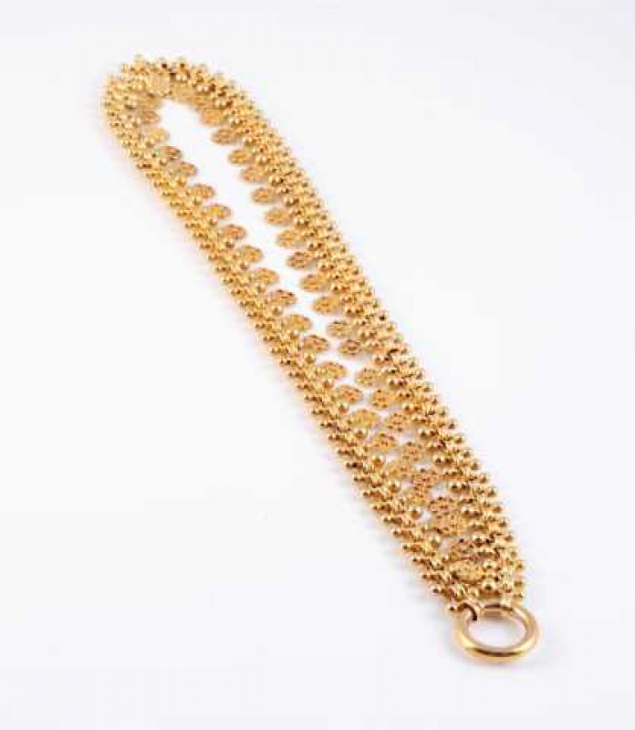 A late Victorian necklace, the double circular articulated links of moulded flower heads alternately spaced with a simple beaded detail link, joined by a large bolt ring clasp. Weight approx. 31.5gms. Length approx. 23.5cm.
