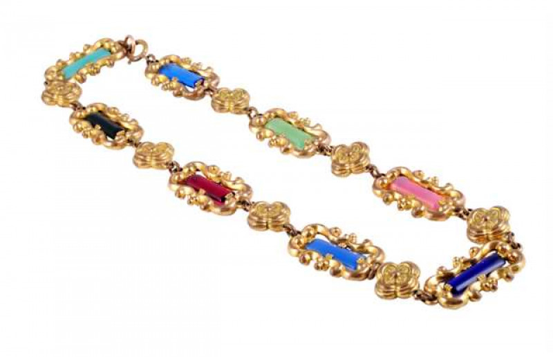 An early Victorian necklace, the eight elaborately moulded rectangular shaped links each set to the centre with a rectangular cut panel of pink, green, blue or red of differing shades, each link alternately spaced by a moulded flowerhead l