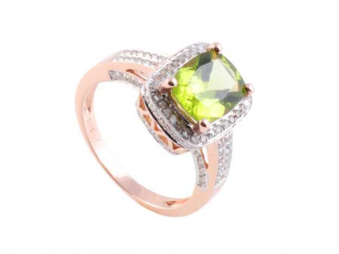 A peridot and diamond ring, the central oval cut peridot four claw set...