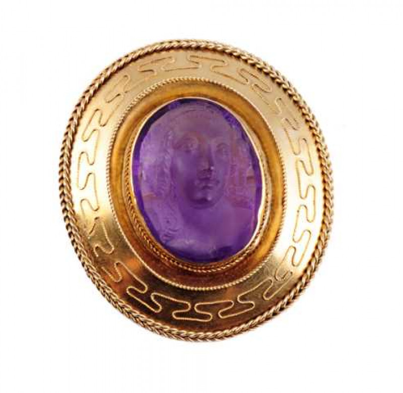 A Victorian cameo brooch, the oval cut amethyst carved to depict a bust of a woman, collet set within a subtly detailed mount of beaded detailing and ropework finishing. Brooch pin fitting. Length approx. 4.5cm. Width approx. 4cm. Weight approx. 15gms.