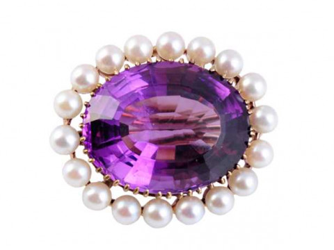An amethyst and cultured pearl brooch, the large oval cut amethyst claw...