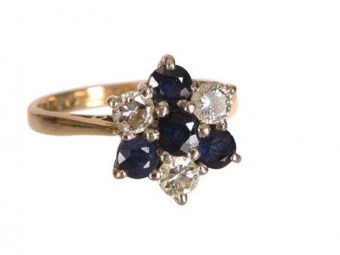 A sapphire and diamond ring, the central round cut sapphire six claw set,...