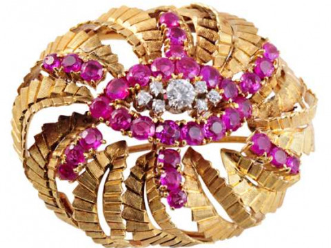 A ruby and diamond brooch, the domed mount set to the top with a brilliant...