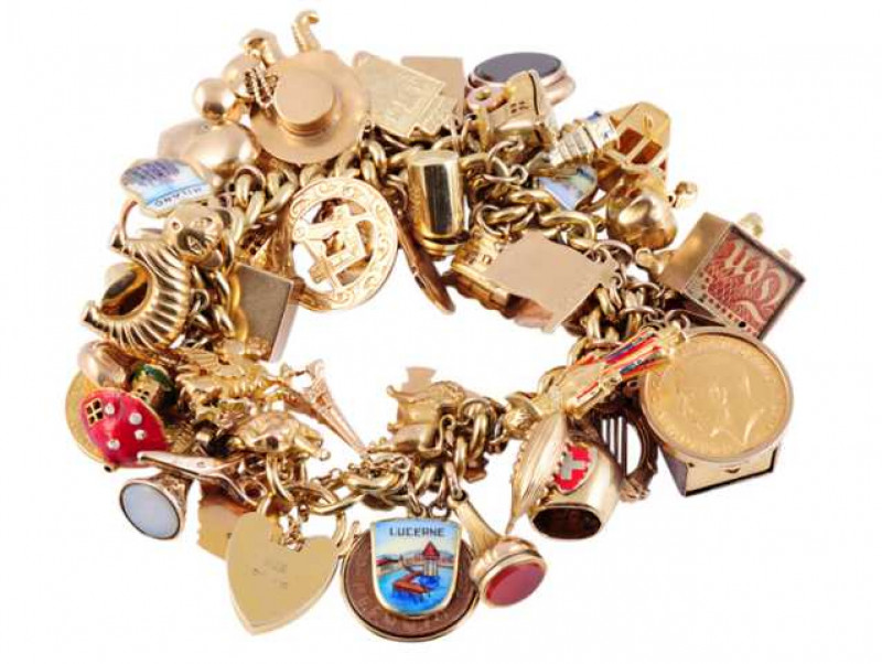 A 9 carat gold charm bracelet, suspending a quantity of predominantly 9 carat gold charms including a 1912 half sovereign. Total weight approximately 140 grams, length 17cm