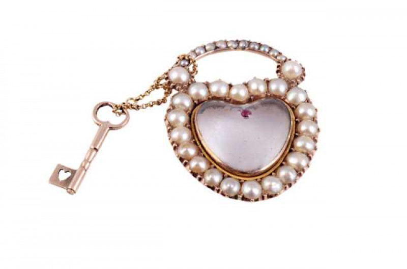 A rock crystal, cultured pearl and ruby locket, circa 1800, the heart shape cut rock crystal locket set to the top with a single ruby highlight, set within a surround of twenty cultured pearls, set to the bottom of thirteen graduating cultured pearls depi