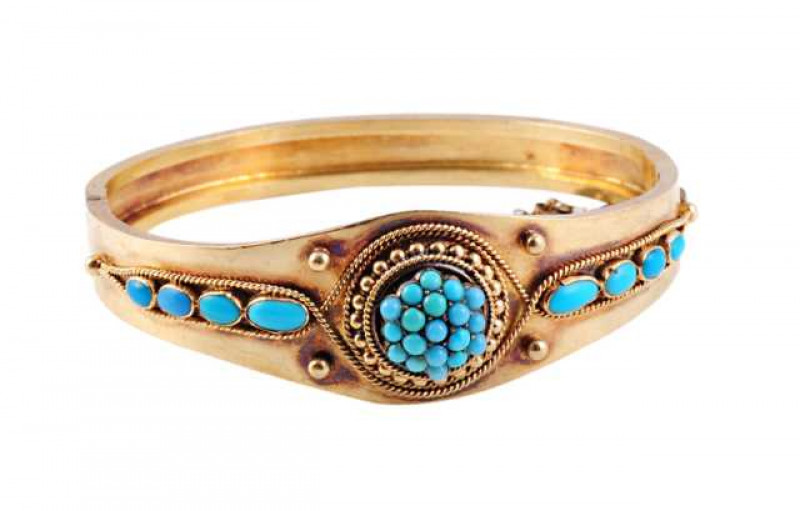 A Victorian turquoise bangle, circa 1870, set to the top with nineteen turquoise highlights, set in a heavily beaded detail mount with ropework detailing to the outer edge, between four graduating collet set oval cut turquoise highlights to each shoulder,