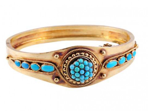 A Victorian turquoise bangle, circa 1870, set to the top with nineteen...