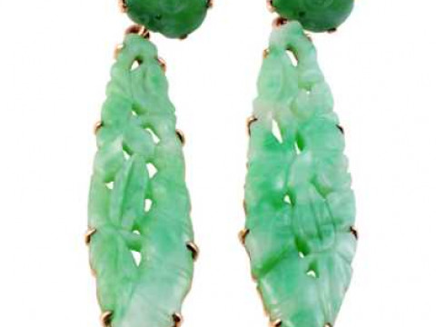 A pair of jade earrings, the carved and pierced oval shaped plaque eight...