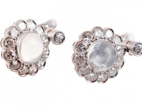 A pair of moonstone and diamond earrings, the round cabochon cut moonstone...
