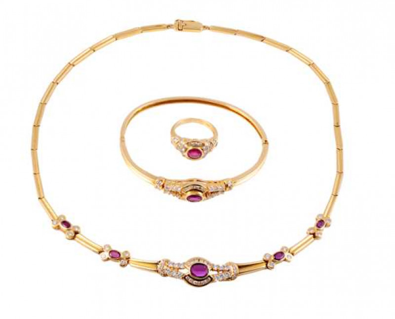 A diamond and ruby necklace, ring and bangle, the necklace of moulded rectangular links, set to the bottom with an oval cut collet set ruby within a surround of twelve illusion set brilliant cut diamonds, a further twelve brilliant cut claw set diamonds a
