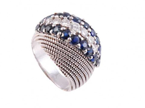 A sapphire and diamond ring, the unusual textured mount design set to...